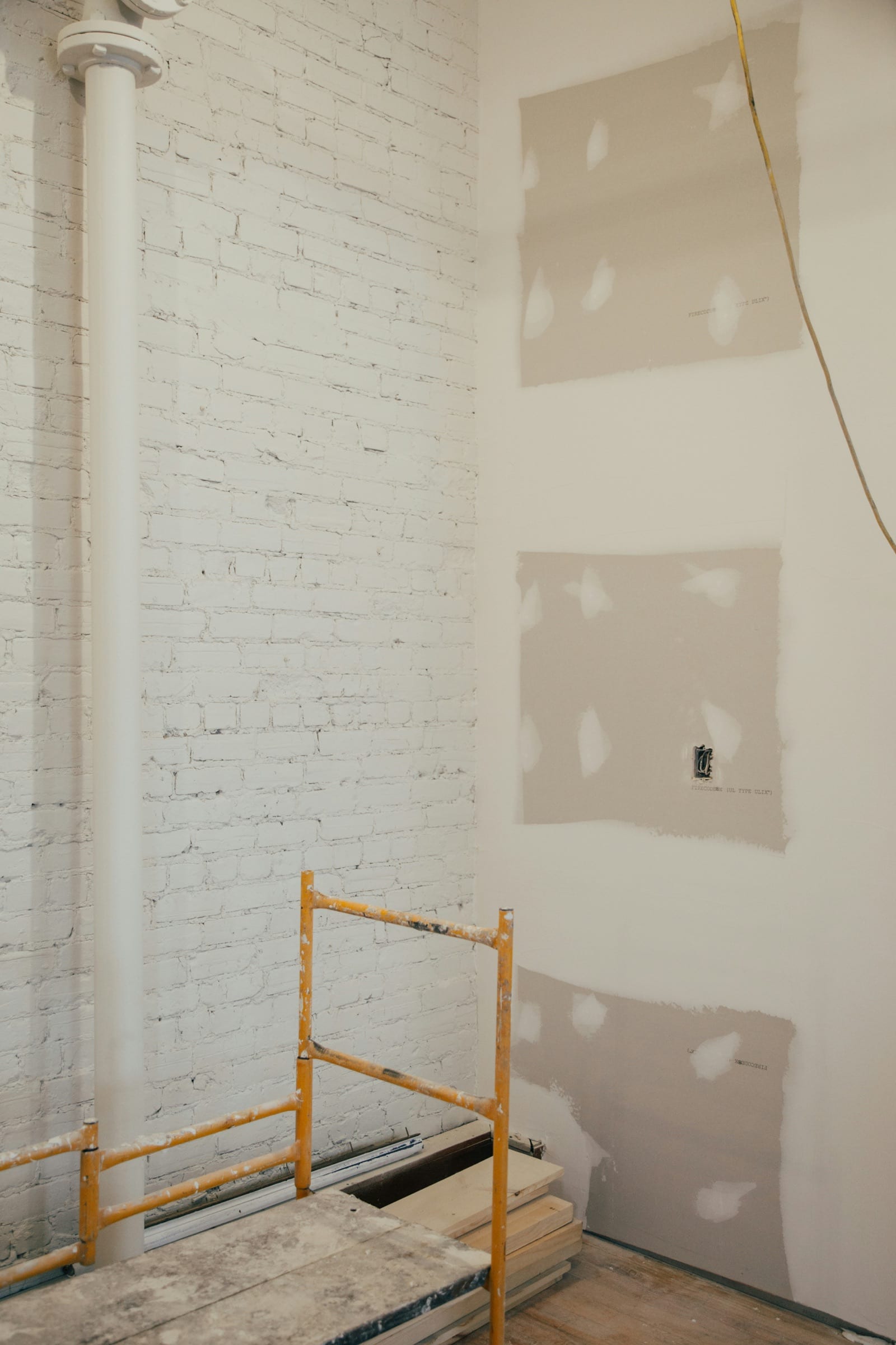 Drywall patches taped over wall damage during a small repair visit.